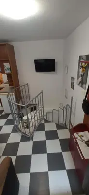 a room with a black and white checkered floor at Апартамент с две спални. in Varna City