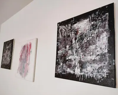 three pieces of art hanging on a white wall at Apartament Panorama - BastetBS in Sveti Vlas