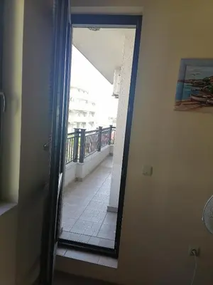 a door leading to a hallway with a balcony at Созопол Дриймс FSM Апартамент in Sozopol