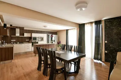 a kitchen and dining room with a table and chairs at Central flat with Monster living room in Varna City