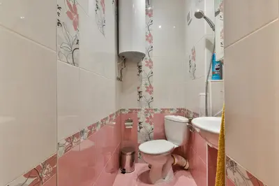 a pink bathroom with a toilet and a sink at Budget central next to sea garden and beach in Varna City