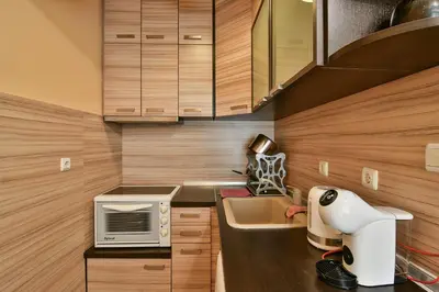 a small kitchen with a sink and a microwave at Budget central next to sea garden and beach in Varna City
