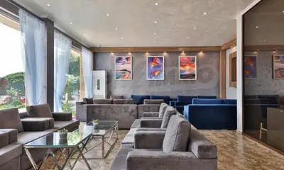 a large living room with couches and a table at Студио Симона 4 - първа линия море in Lozenets
