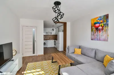 a living room with a couch and a tv at Top location flats in Varna in Varna City
