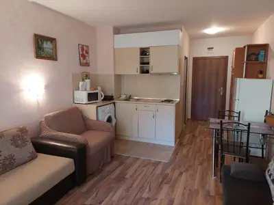 a living room with a couch and a kitchen at Святой Влас, комплекс Sea Breeze in Sveti Vlas
