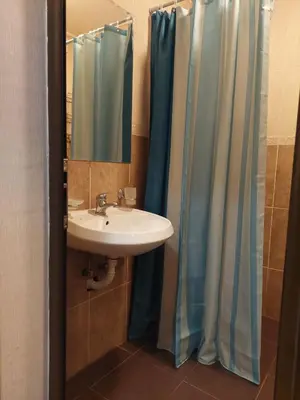 a bathroom with a sink and a shower curtain at Святой Влас, комплекс Sea Breeze in Sveti Vlas