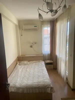 a bedroom with a bed and a window at Pomorie Apartment in Pomorie
