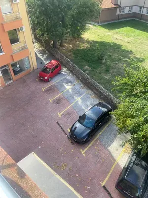 an aerial view of two cars parked in a parking lot at Pomorie Apartment in Pomorie