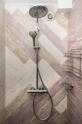 a shower with a shower head in a bathroom at Cozy central flat in Varna Downtown in Varna City