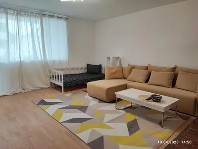 a living room with a couch and a table at Royal Apartments Varna in Varna City