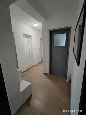 an empty hallway with a door and a tile floor at Royal Apartments Varna in Varna City