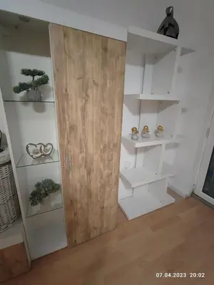 a room with white shelves and a wooden door at Royal Apartments Varna in Varna City