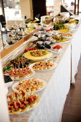 a buffet line with many plates of food at BIATO APARTMENTS - ALL INCLUSIVE in Sunny Beach