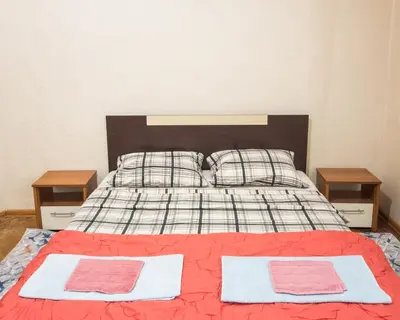 a bed with two pillows and two night stands at Summer Square - 2 bedrooms Retro Flat with great location, 1st fl in Burgas City