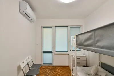 a dorm room with a bunk bed and a window at Central 3BR with parking nearby Opera in Varna City