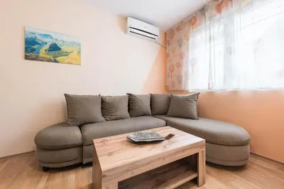 a living room with a couch and a coffee table at Sea&Park Apartment in Varna City