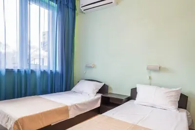 two beds in a room with a window at Sea&Park Apartment in Varna City
