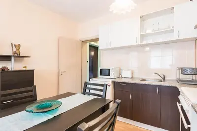 a kitchen and dining room with a table and chairs at Sea&Park Apartment in Varna City