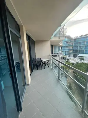 a balcony of a building with a table and chairs at Large apartment in Sunny Beach in Sunny Beach
