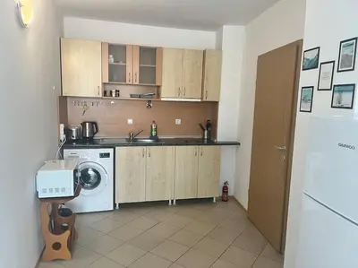 a kitchen with a sink and a washing machine at Large apartment in Sunny Beach in Sunny Beach
