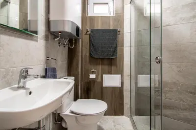 a bathroom with a toilet and a sink and a shower at Top location in center and paid parking in Varna City
