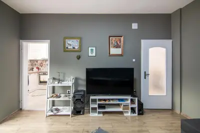 a living room with a flat screen tv on a wall at Top location in center and paid parking in Varna City
