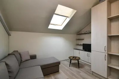 a living room with a couch and a skylight at Budget studio in Varna center unde roof in Varna City