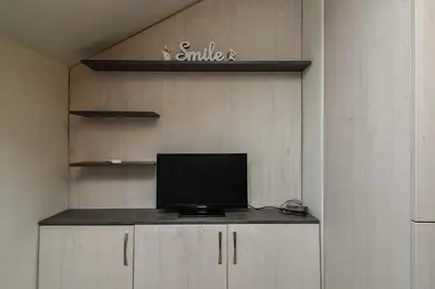 a tv sitting on a shelf in a room at Budget studio in Varna center unde roof in Varna City