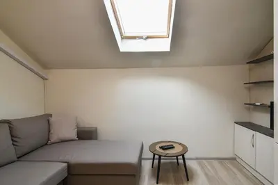 a living room with a couch and a skylight at Budget studio in Varna center unde roof in Varna City