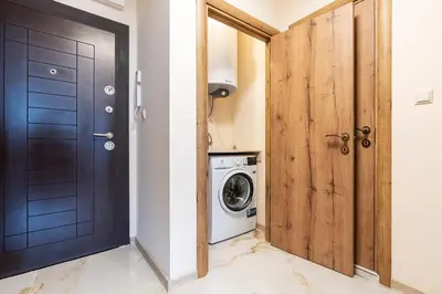 a bathroom with a black door and a washing machine at M1 Pool and Beach View Apartment in Burgas City