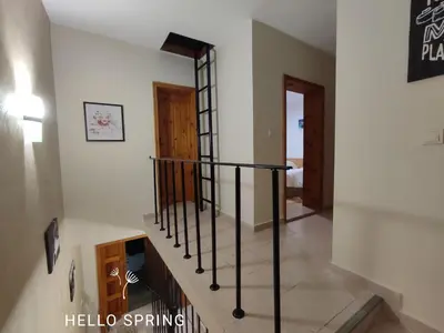 a staircase with black railings in a house at Longoz in Bliznatsi
