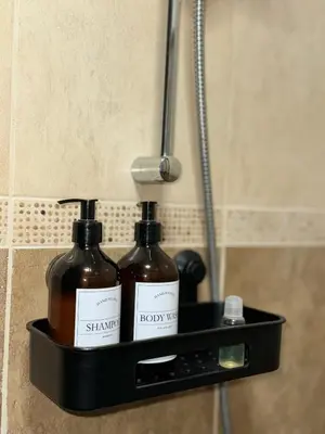 two bottles of soap on a shelf in a bathroom at Студия Sea Breeze in Sveti Vlas