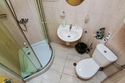 a bathroom with a toilet and a sink and a shower at Budget 1BR flat downtown Varna in Varna City