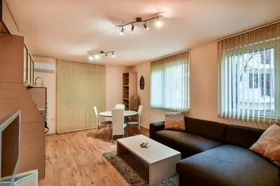 a living room with a couch and a table at Budget 1BR flat downtown Varna in Varna City