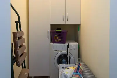 a laundry room with a washing machine with a clock on it at Super Central flat in Varna in Varna City