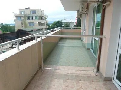 a balcony with a railing on a building at Семеен Хотел Детелини in Primorsko