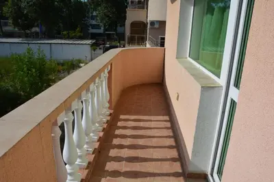 a stairway leading up to a building with a window at Семеен Хотел Детелини in Primorsko