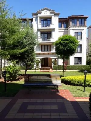 a park bench in front of a building at Апартамент Orange в местност Каваци, Созопол in Sozopol