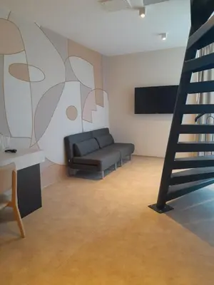 a living room with a couch and a staircase at Hotel Zenith in Sunny Beach
