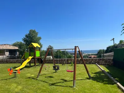 a playground with a slide and a swing set at Kristin Palace in Obzor