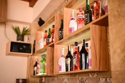 a row of bottles of alcohol on a wall at Kristin Palace in Obzor