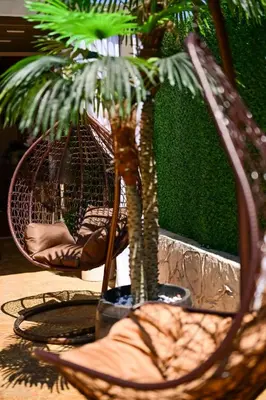 a table with two chairs and a palm tree at Kristin Palace in Obzor