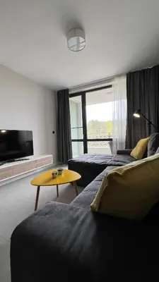 a living room with a couch and a table at Blue Heaven Apartment Kavaci Sozopol in Sozopol