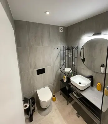 a bathroom with a toilet and a sink and a mirror at Blue Heaven Apartment Kavaci Sozopol in Sozopol