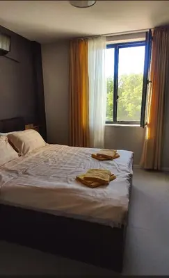 a bedroom with a bed with two towels on it at Blue Heaven Apartment Kavaci Sozopol in Sozopol