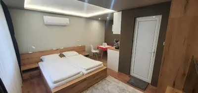 a small room with a bed and a kitchen at KALI GUEST ROOM in Varna City