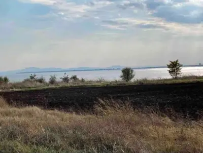 a field of grass with a body of water at 1 Bed Apt, Close To Ravda Beach in Ravda