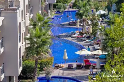 a resort with two pools with people swimming in them at Luxurious Studio Apt,4* Cascadas in Sunny Beach