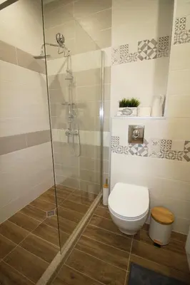 a bathroom with a toilet and a glass shower at Doris Beach studio D09 and studio D10 in Burgas City
