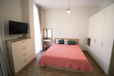 a bedroom with a bed and a flat screen tv at Doris Beach studio D09 and studio D10 in Burgas City